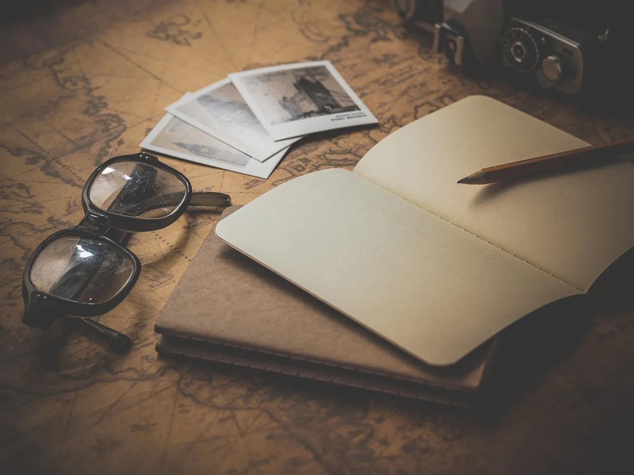 Photo showing notepad, glasses, travel and planning.