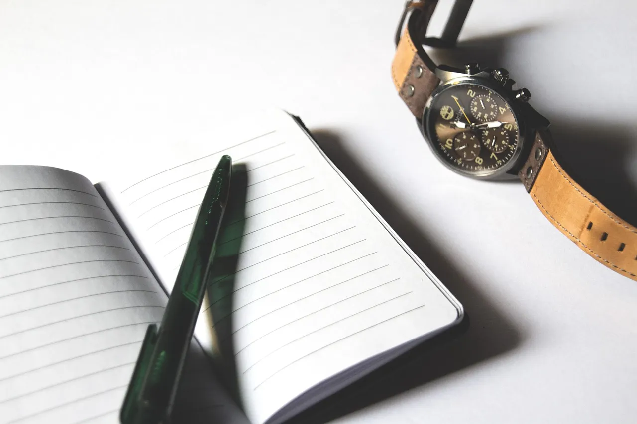 Photo showing checklist, paper, notebook and watch.