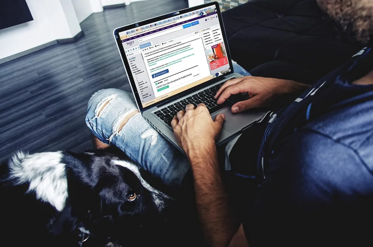 Photo showing laptop, man, computer and desk.