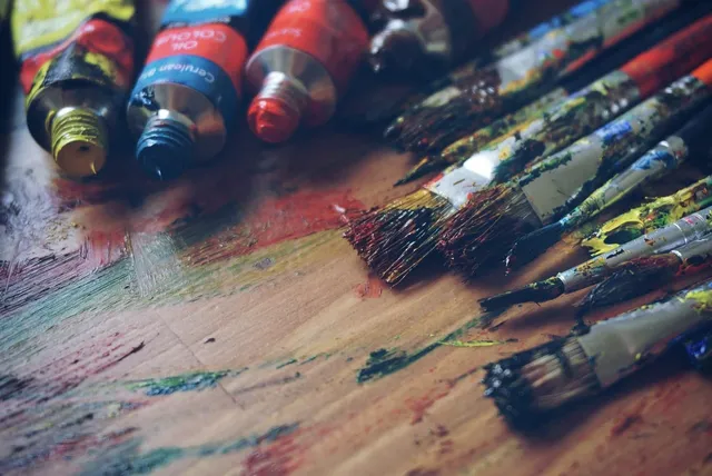 Photo showing art, art supplies and artist.