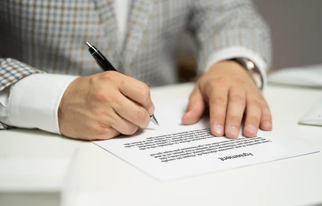 Photo showing contract, agreement and signing a contract.