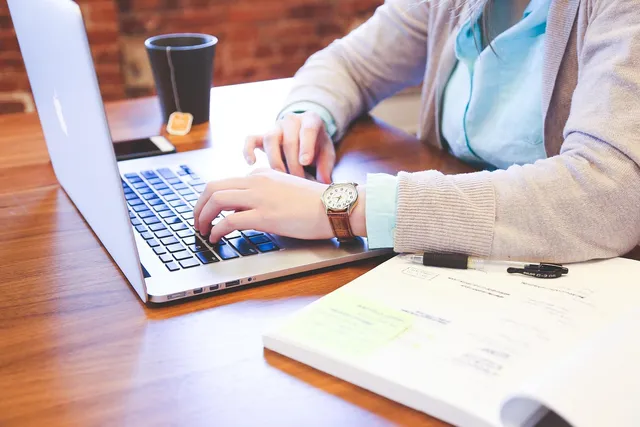 Photo showing student, typing and keyboard.