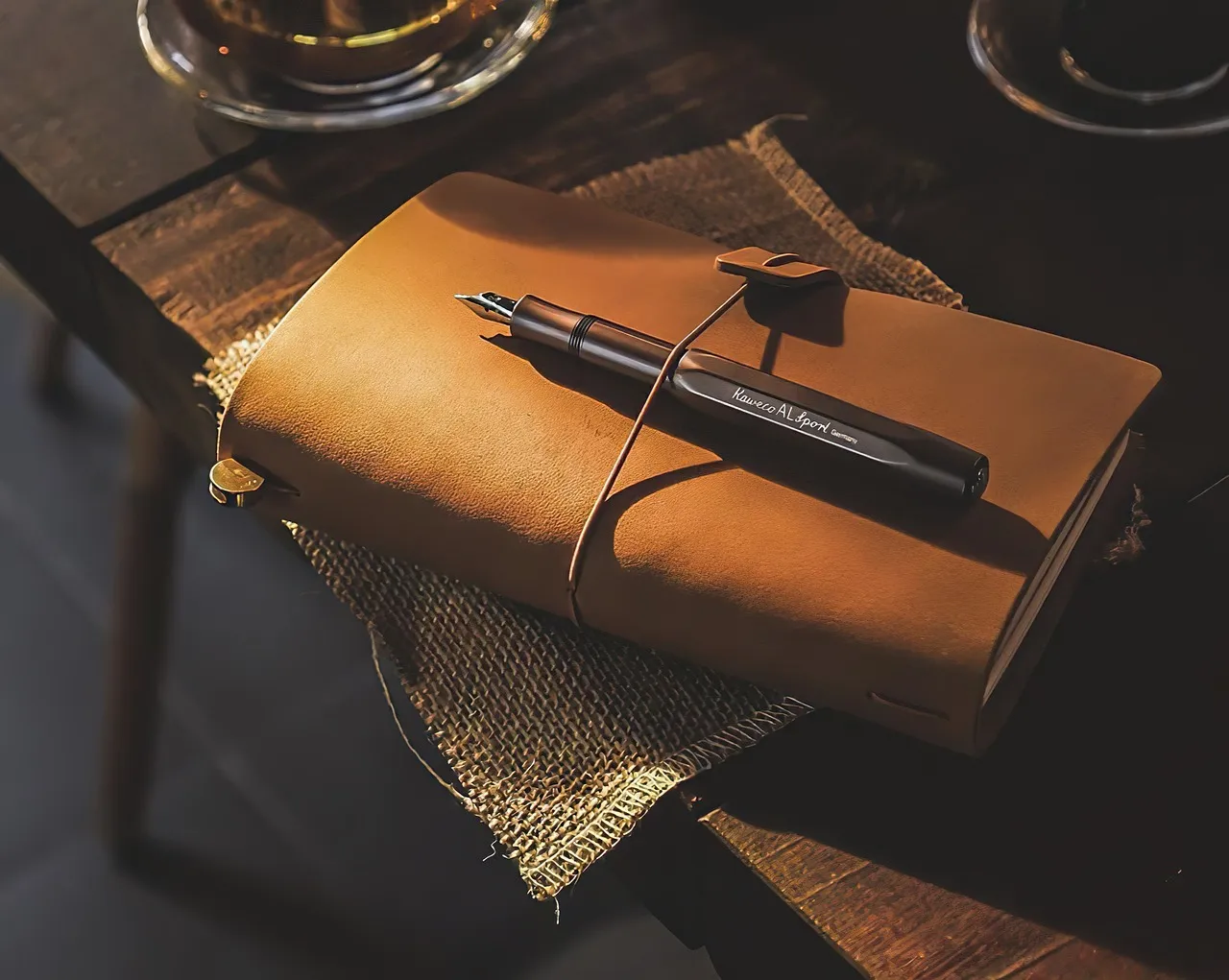 Photo showing book, pen, notebook and diary.