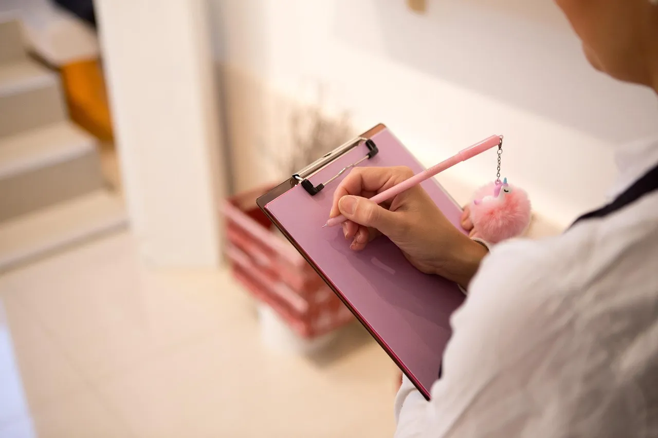 Photo showing writing, beautiful flowers, pencil and note.