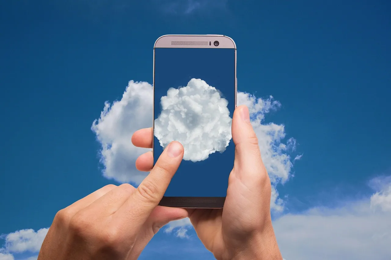 Photo showing cloud, finger, smartphone and phone.