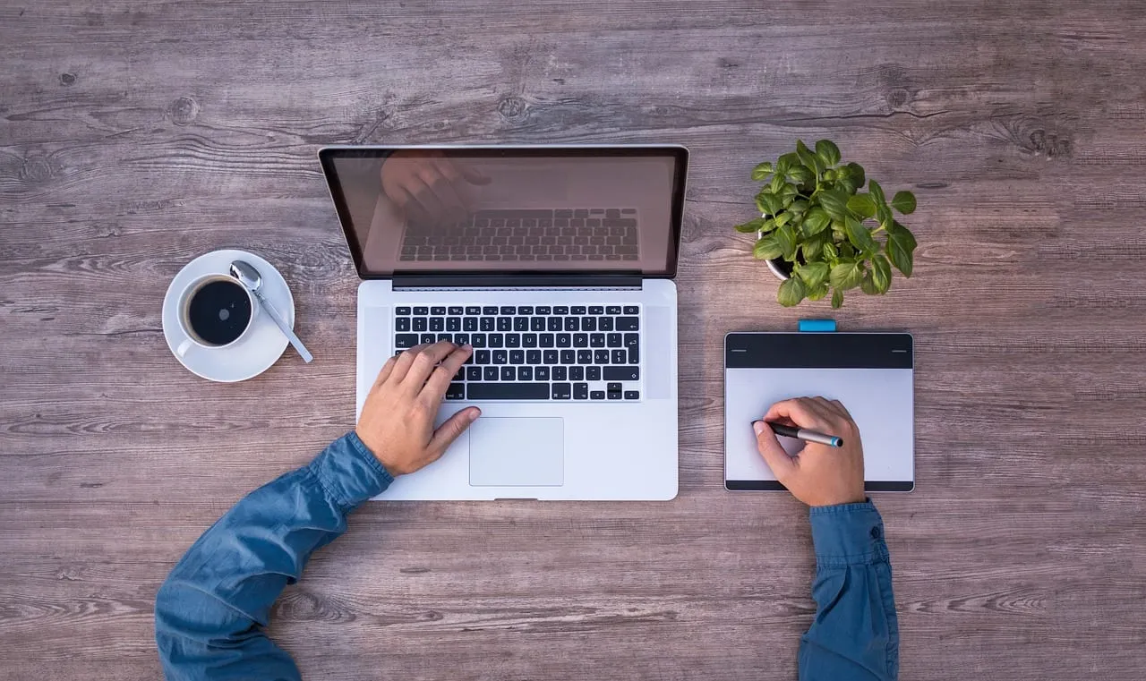 Photo showing laptop, mockup and graphics tablet.