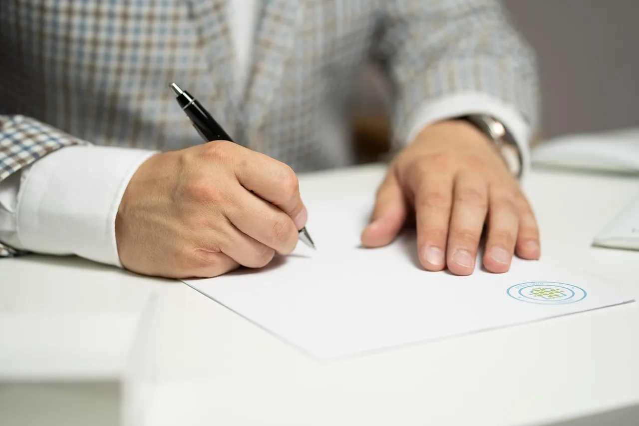 Photo showing man, sign, paper and write.