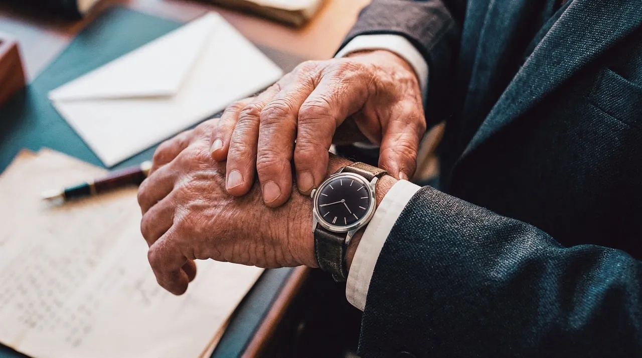 Photo showing watch, suit, wrist and time.