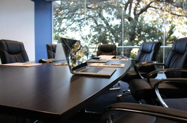 Photo showing office, boardroom and meeting.