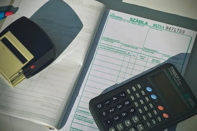 Photo showing calculator, invoice and finance.