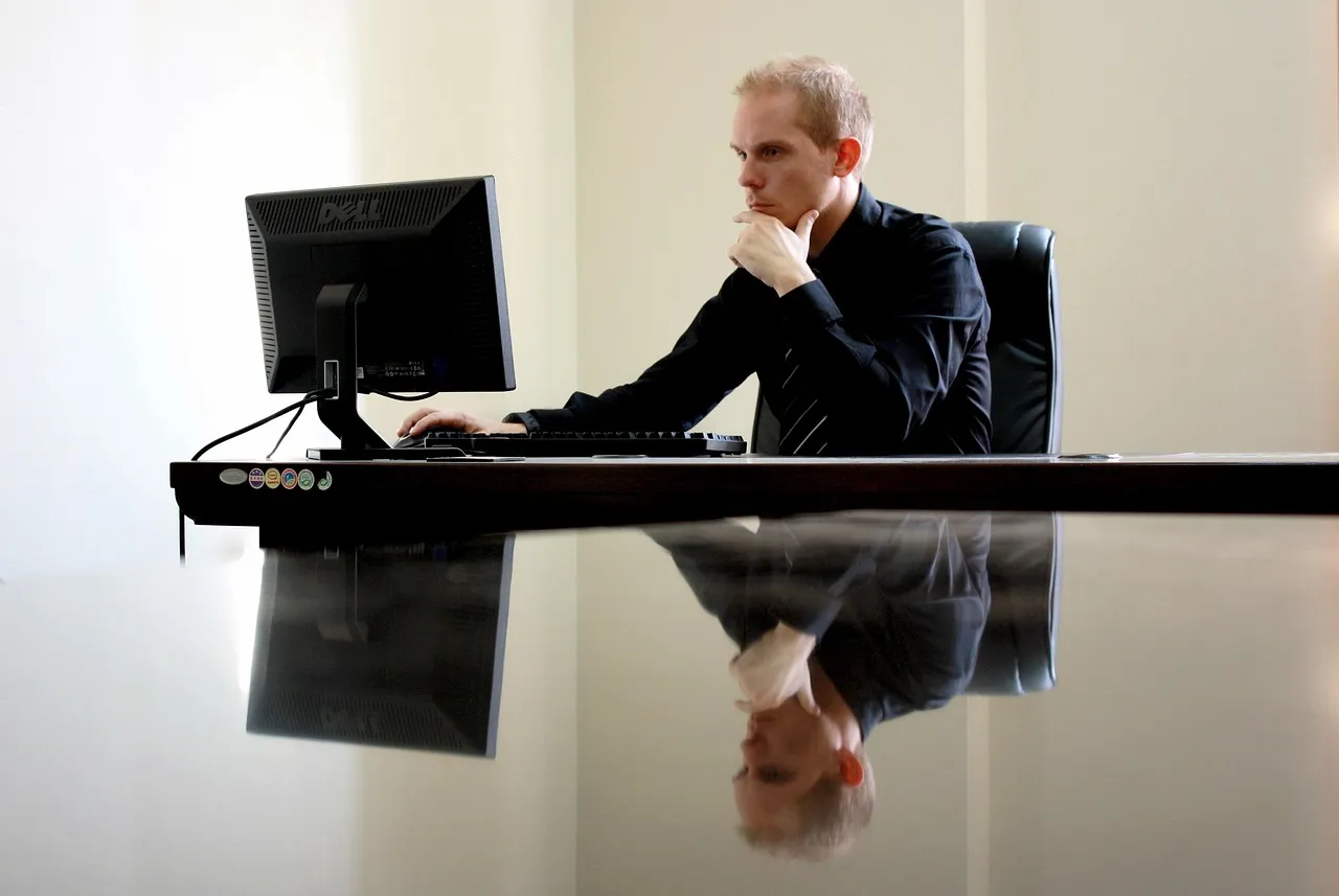 Photo showing business, businessman, chair and computer.