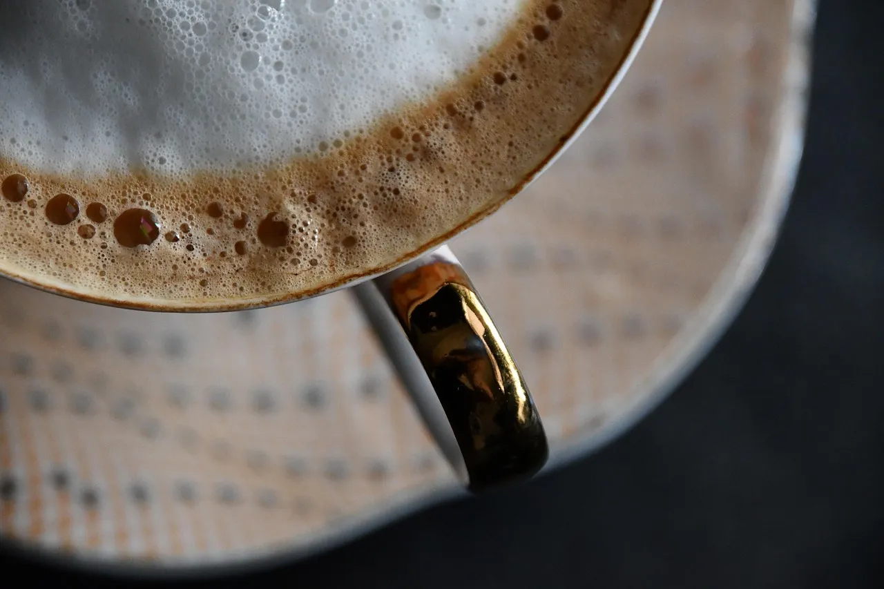 Photo showing coffee, orange, gold and work desk.