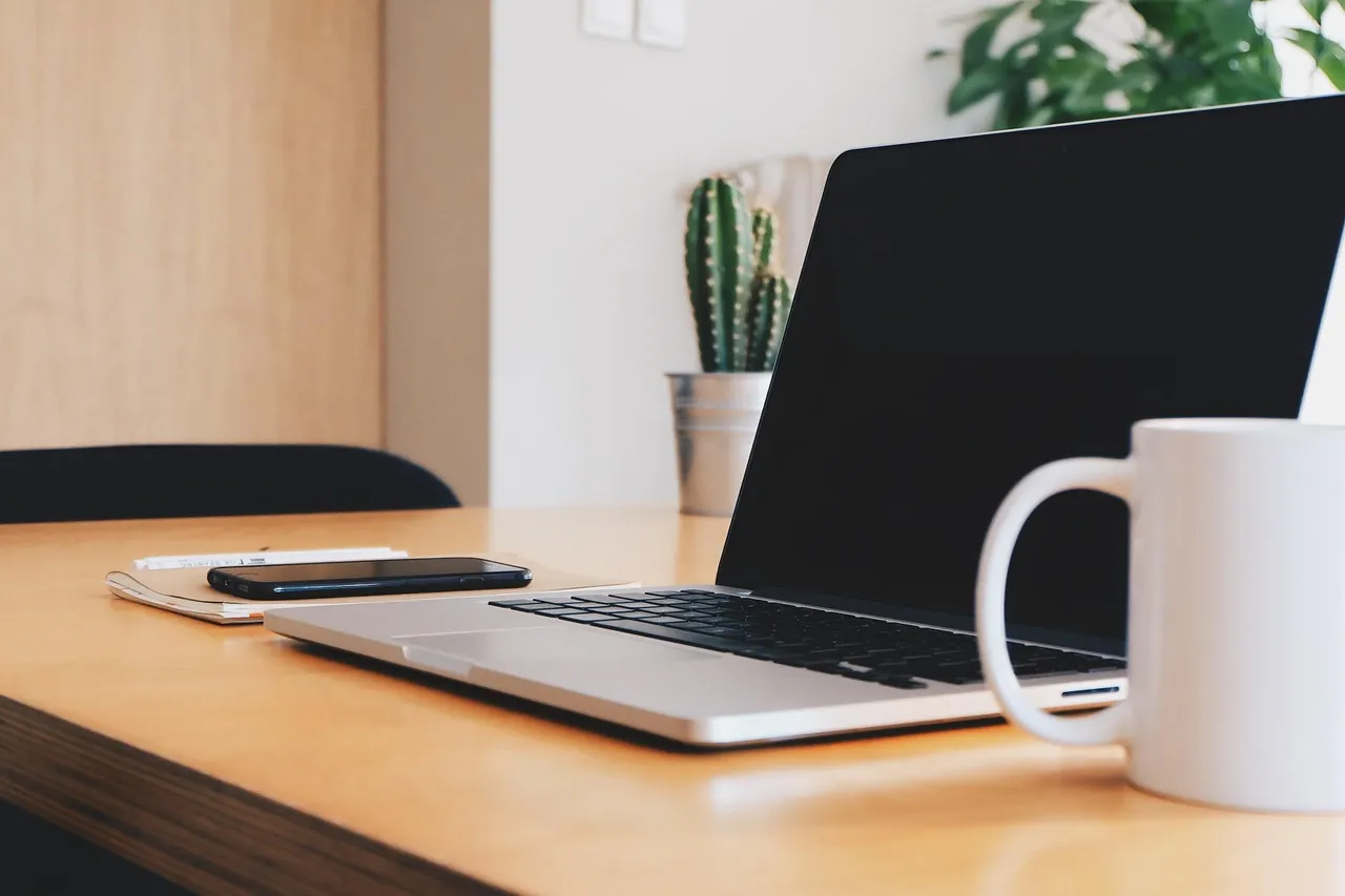 Photo showing office, coffee cup, desk and business.