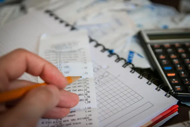 Photo showing money, bills and calculator.