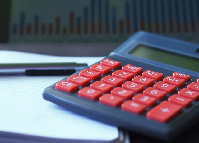 Photo showing calculator, calculation and assurance.