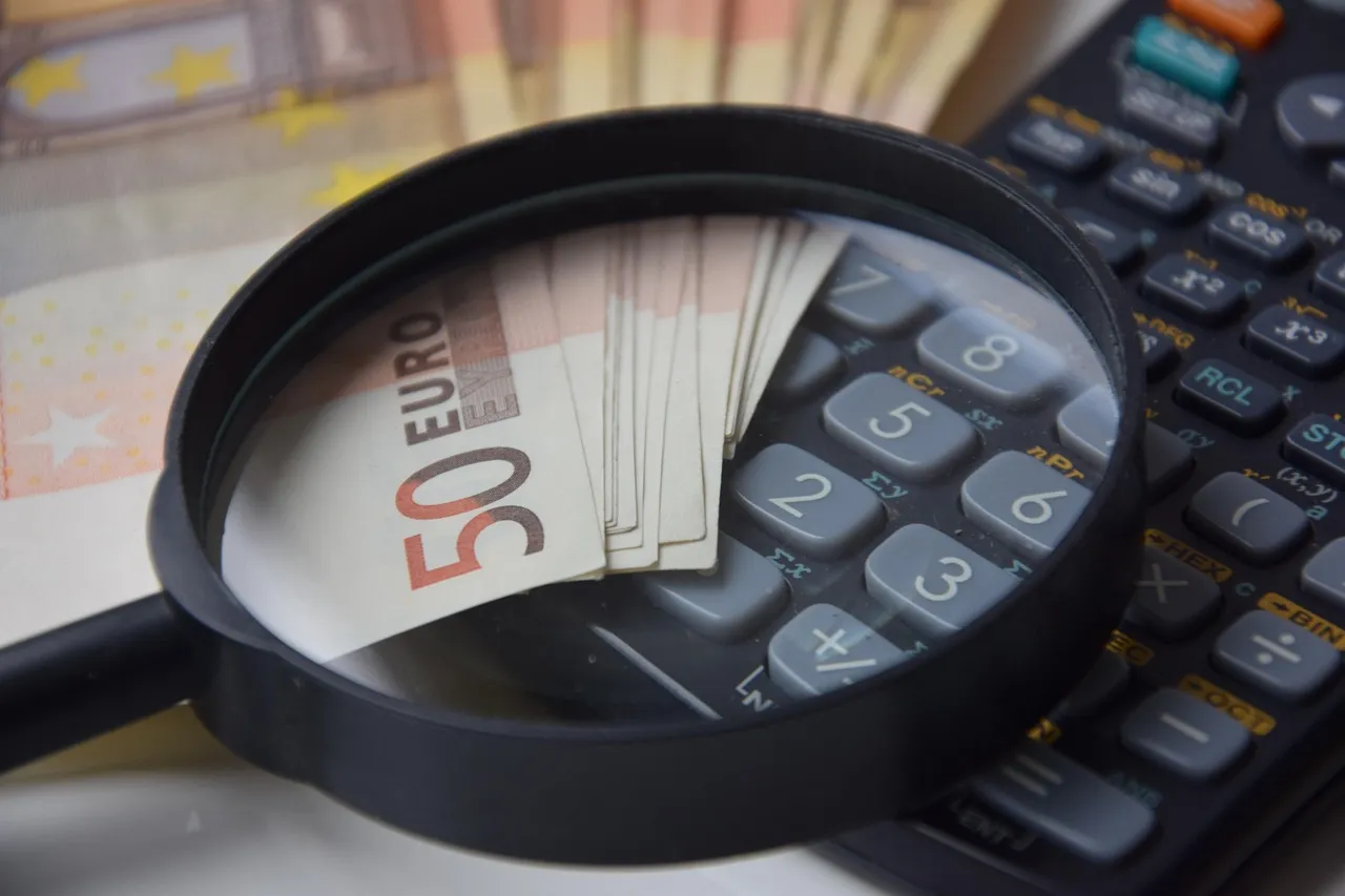 Photo showing money, money calculator, calculator and calculation.
