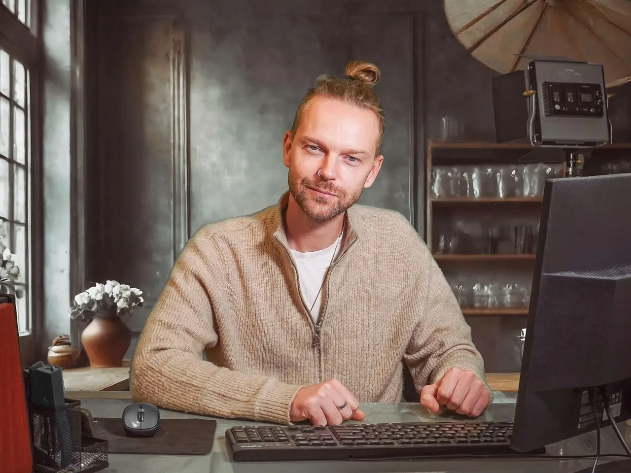 Photo showing man, desk, computer and adult.