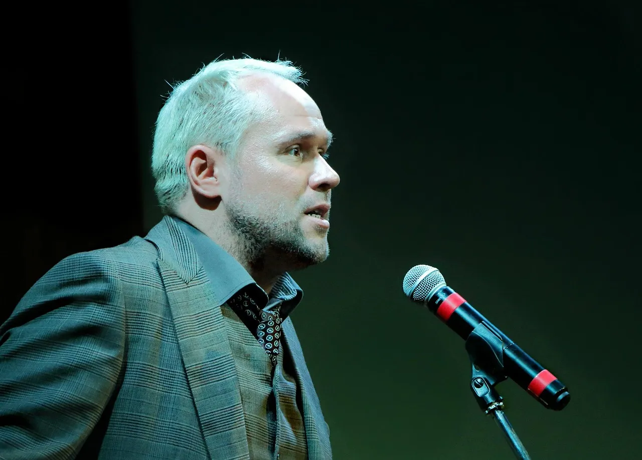 Photo showing man, speech and speaker.