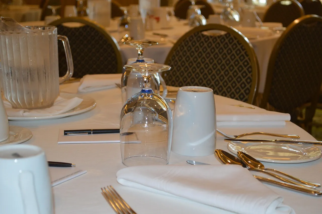 Photo showing table, table setting, conference and meeting.