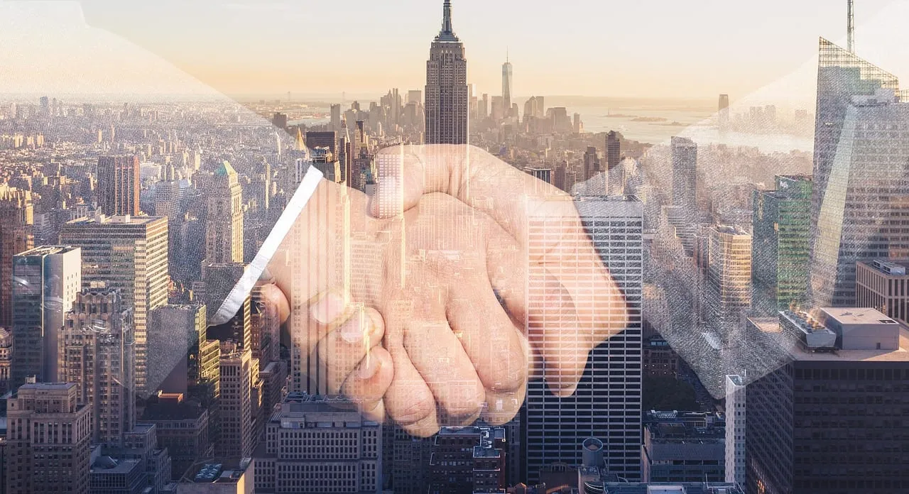 Photo showing shaking hands, handshake and skyline.