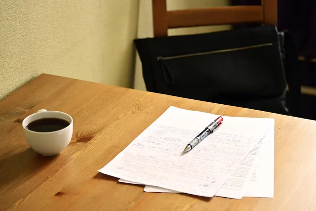 Photo showing correcting, papers and english teacher.