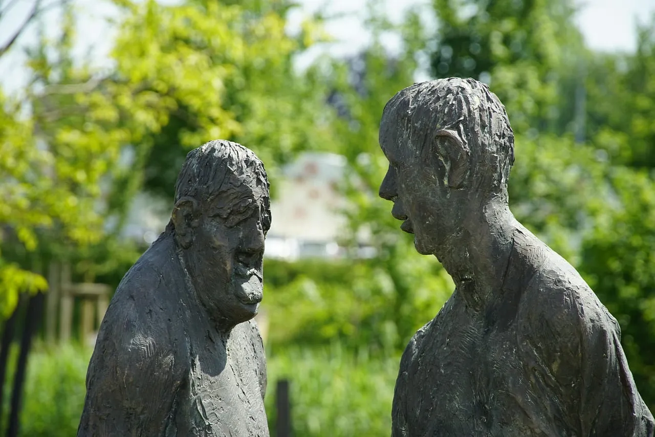 Photo showing talking, people, sculpture and conversation.