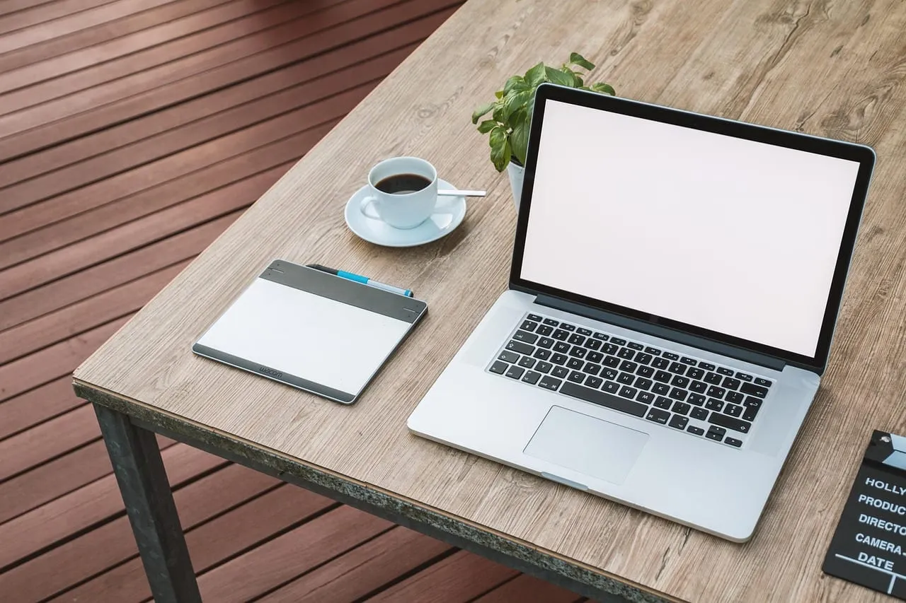Photo showing laptop, workspace, notebook and work.