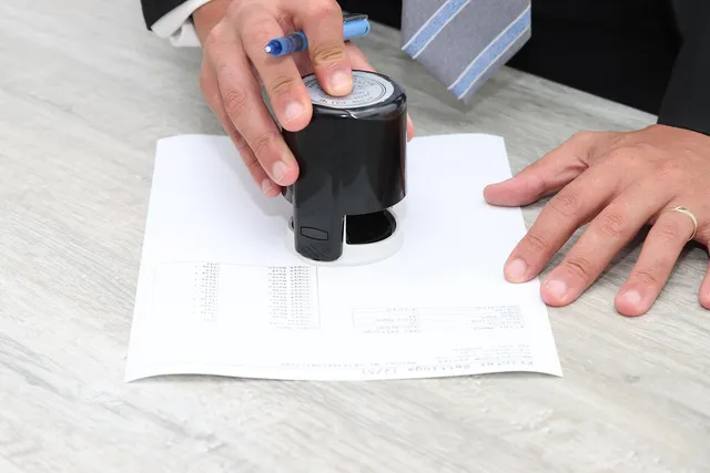 Photo showing signing, paper and document.