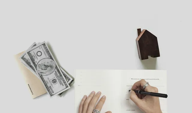 Photo showing mortgage, house and money.