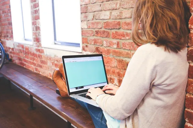 Photo showing student, typing and keyboard.