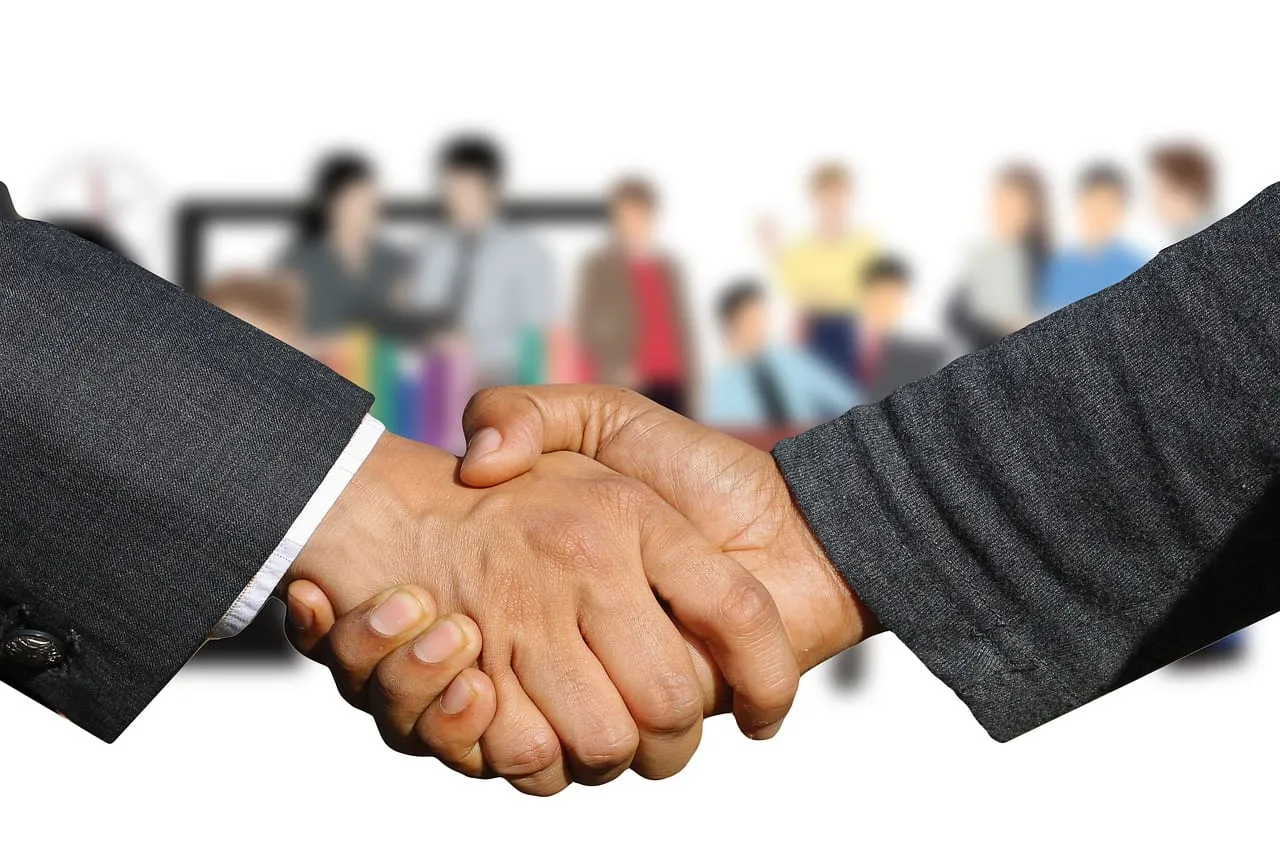 Photo showing shaking hands, handshake, hands and welcome.